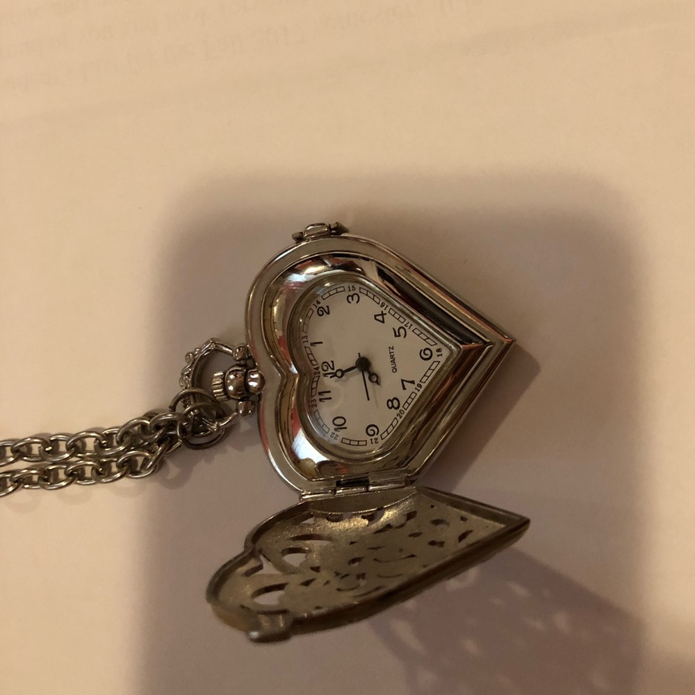 Open heart necklace with clock on the inside